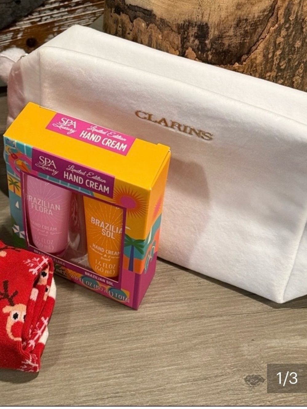 Clarins Cosmetic Pouch with Holiday reindeer, socks, and lotions